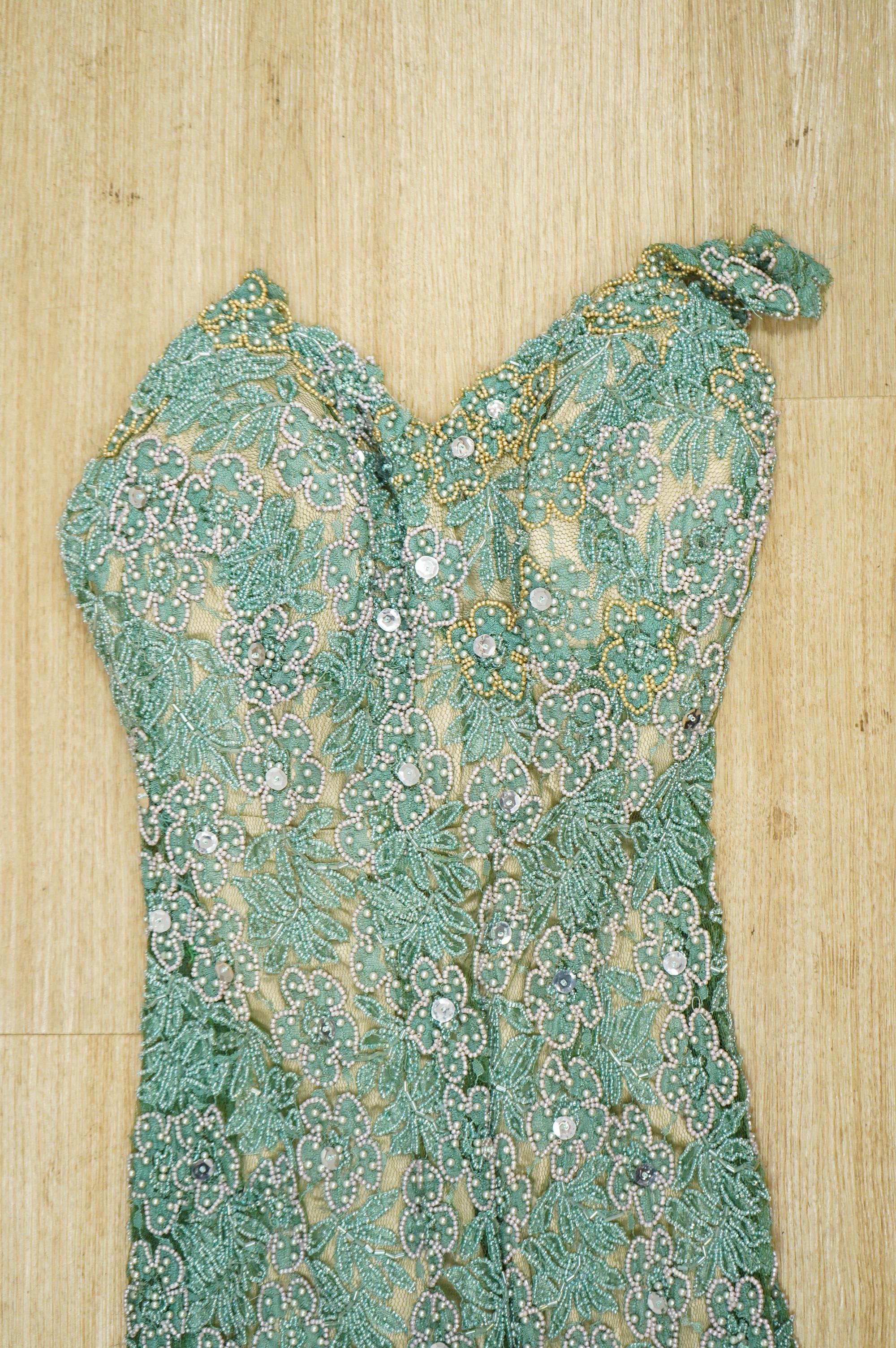 A 1960’s-70’s light green beaded and sequin floral net, fitted full length evening dress. 134cm long